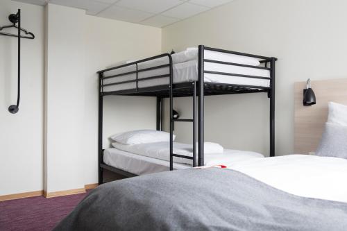 two bunk beds in a room with a bed at Citybox Oslo in Oslo