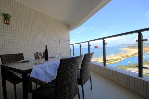 a dining room with a table and a view of the ocean at Coast-Inn Hailing Island in Yangjiang