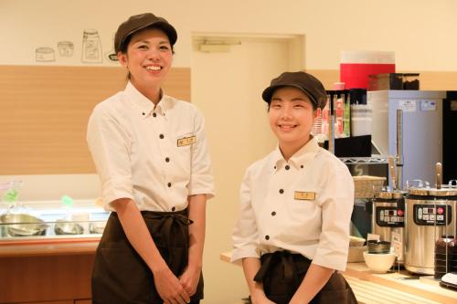 two chefs standing next to each other in a kitchen at Richmond Hotel Higashi Osaka in Osaka