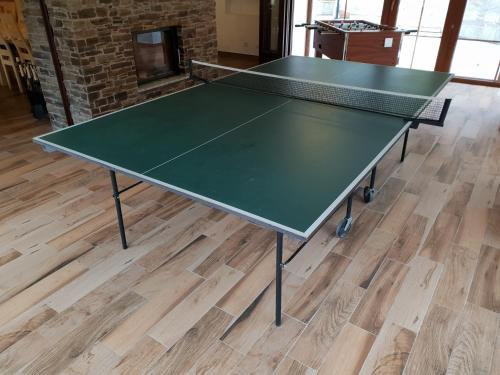 two ping pong tables in a room with wooden floors at Club Rezidence Pod Lučí in Loučovice