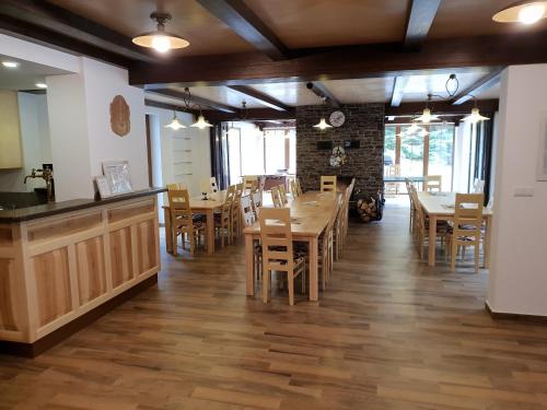 a dining room with wooden tables and chairs at Club Rezidence Pod Lučí in Loučovice