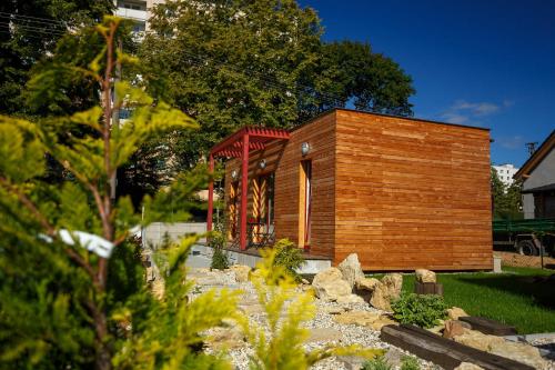 a small wooden building in a yard with rocks at Apartmány Kopacka in Svitavy