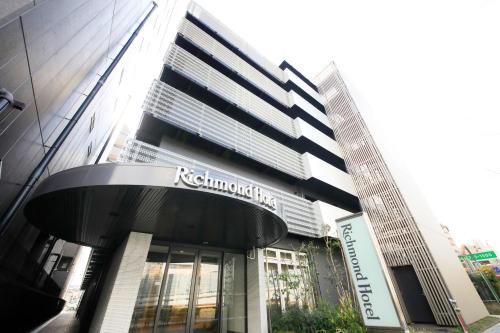 a building with a sign on the front of it at Richmond Hotel Higashi Osaka in Osaka