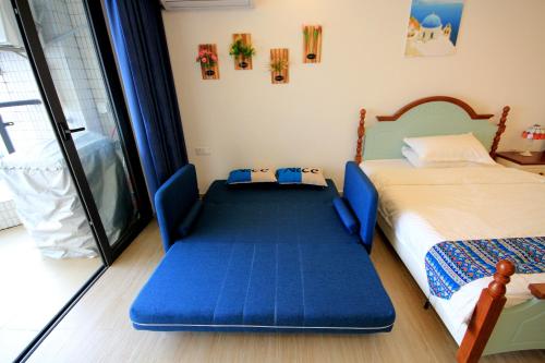 a bedroom with a bed and a large window at Coast-Inn Hailing Island in Yangjiang