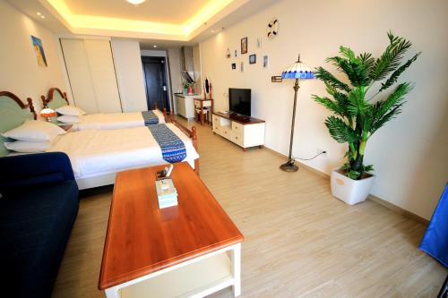 a bedroom with a bed and a palm tree in it at Coast-Inn Hailing Island in Yangjiang