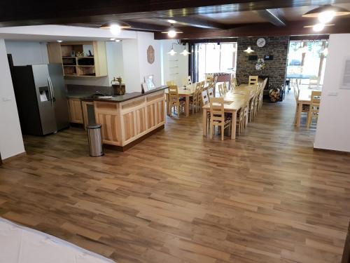 a kitchen and dining room with wooden floors and a table at Club Rezidence Pod Lučí in Loučovice