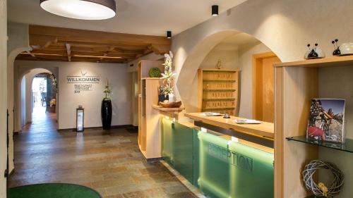 a kitchen with a counter and an archway in a room at Hotel Hubertushof in Lermoos