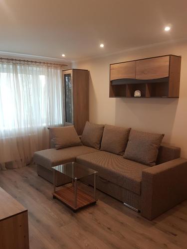 a living room with a couch and a glass table at Boatman's harbor in Liepāja