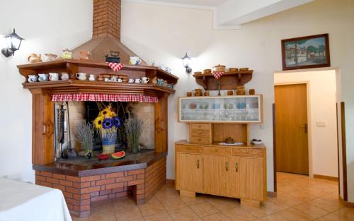 a living room with a fireplace and a room with at Nadia's house in Pićan
