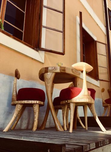 two chairs and a table on a porch at Hotel Barcadam in Banská Štiavnica