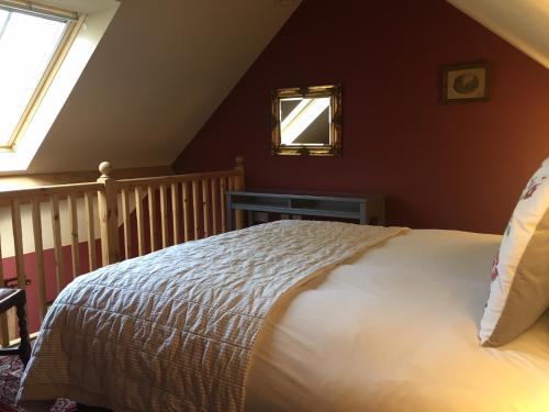 a bedroom with a bed and a mirror on the wall at The Blackboys Inn in Framfield
