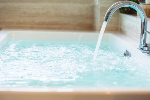 a sink with water pouring from a faucet at Bluemoon Sardinia in Cagliari