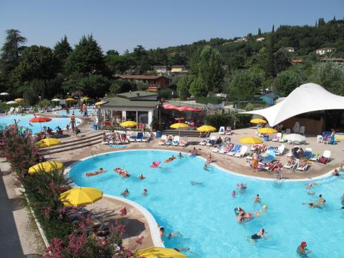 a group of people in a pool at a resort at Campeggio Europa Silvella in San Felice del Benaco