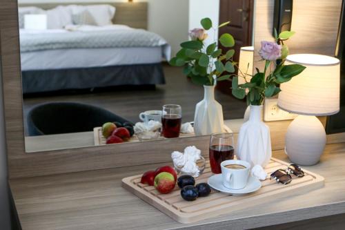 a tray of fruit on a table in a hotel room at Hotel Antonio in Uzhhorod