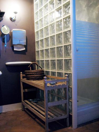 a bathroom with a glass block wall with a sink and a tub at Casa del Mediterraneo in Barcelona