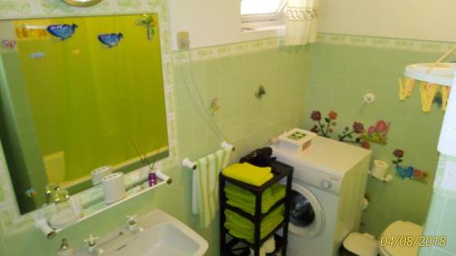 a bathroom with a sink and a washing machine at Sunny flat In Machico city in Machico