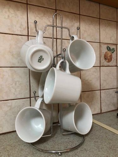 a group of white cups hanging on a wall at Leonidio Climb2red home in Leonidion