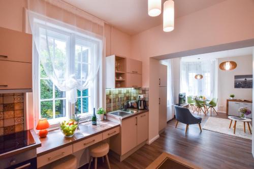 a kitchen with a counter and a large window at Christine Apartment close to the Buda Castle in Budapest