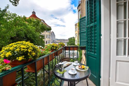 a balcony with a table with food on it at Christine Apartment close to the Buda Castle in Budapest