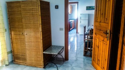 a room with a wooden cabinet and a chair at Appartamenti Luongo in Ischia