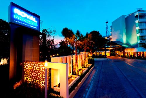 a sign on the side of a street at night at Royal Princess Larn Luang - SHA Extra Plus in Bangkok
