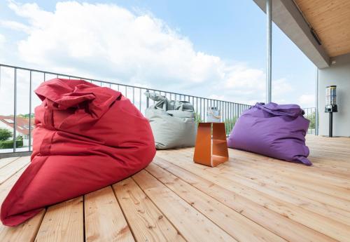 a red bean bag chair sitting on a balcony at Hotel Schönbuch in Pliezhausen