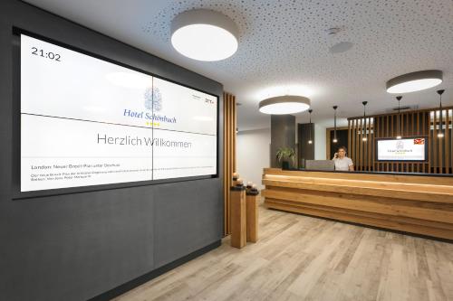 a woman standing in front of a health clinic at Hotel Schönbuch in Pliezhausen