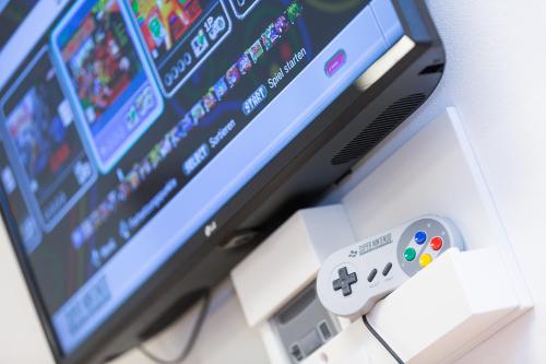 a video game controller sitting next to a computer monitor at Hotel Schönbuch in Pliezhausen