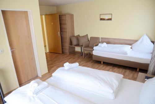 a hotel room with two beds and a couch at La Stella in Süßen