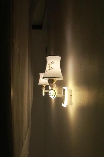 a couple of lights on a wall in a room at Green Ocean Bay in Arugam Bay