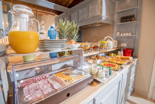 a buffet with a lot of food in a kitchen at Relais dei Molini - Villa dei Molini in Castagneto Carducci