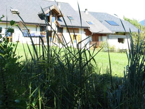 a house with a lot of tall grass in front of it at La Ferme De Noémie in Mercury