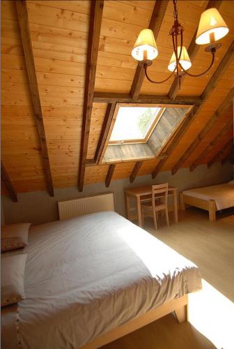 a bedroom with a large bed and a window at La Ferme De Noémie in Mercury