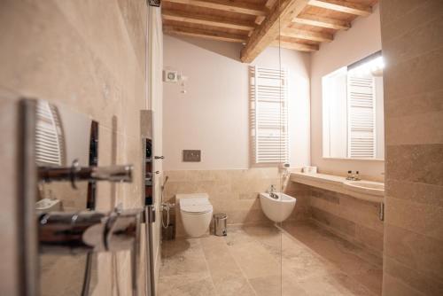a bathroom with a toilet and a sink at Relais dei Molini - Villa dei Molini in Castagneto Carducci