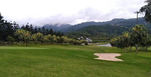 a view of a golf course with palm trees and a golf ball at Life Leisure Resort in Guanxi