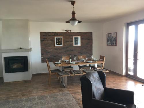 a dining room with a table and chairs and a fireplace at U Floderů in Bavory