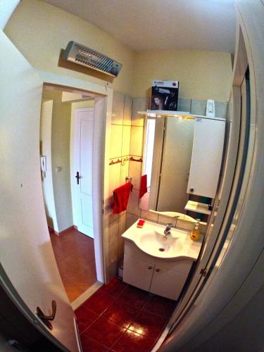 a small bathroom with a sink and a mirror at Backpackers Fairytale Hostel in Split