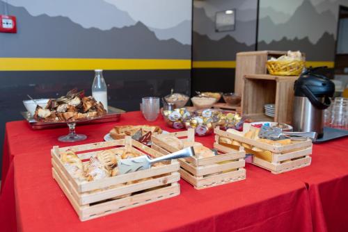 a table with wooden crates of food on a red table cloth at Roma Scout Center in Rome