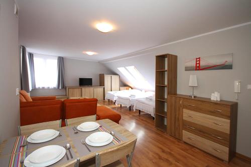 a living room with a bed and a dining room at Apartamenty Olsztyn in Olsztyn