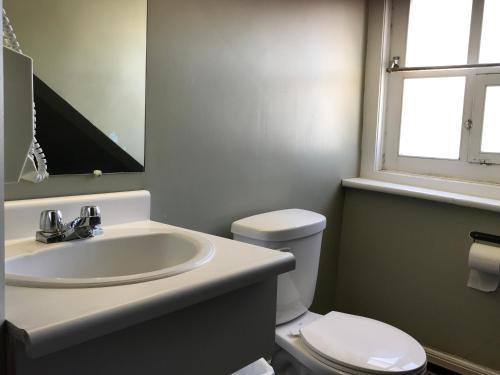 a bathroom with a sink and a toilet at Auberge St-Louis in Quebec City