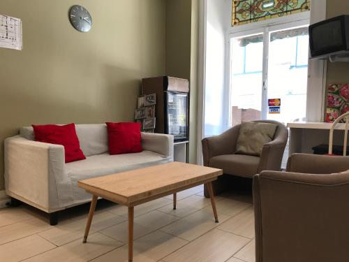 a living room with a couch and two chairs and a table at Auberge St-Louis in Quebec City