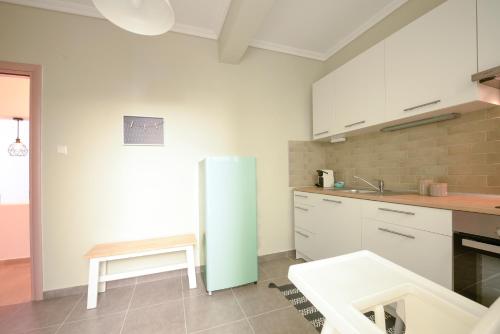 a kitchen with a refrigerator and a table in it at Seaside Flat in Kavála
