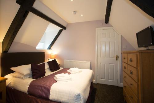 a bedroom with a bed with a tv on top at Georgian House & Mews in York