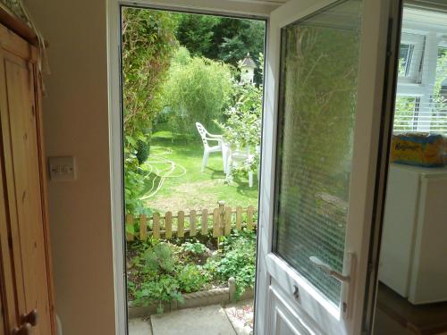 a sliding glass door with a view of a garden at Hillside Self Catering in Salisbury