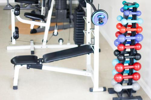 a gym with a rack of dumbbells and weights at Hotel City Hall in São José dos Campos