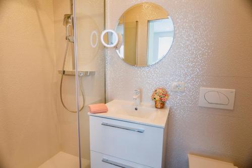 a bathroom with a sink and a mirror at Rose Gold Rooms & Studio with balcony in Split