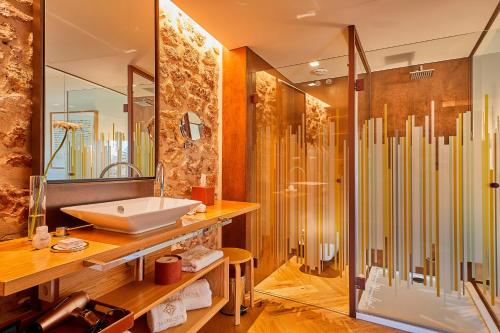 a bathroom with a sink and a shower at Sa Creu Nova Petit Palais Art & Spa in Campos