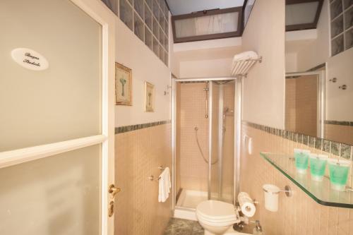 a bathroom with a shower and a toilet and a sink at Casa Rovai Guest House in Florence