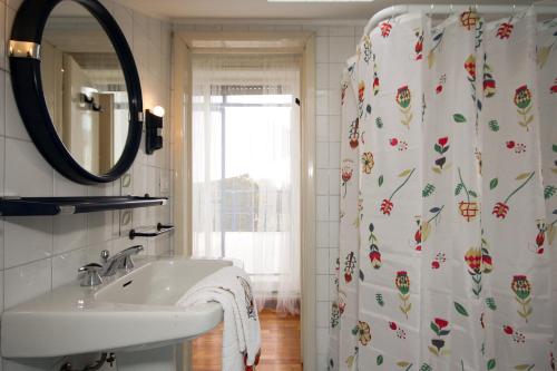 a bathroom with a sink and a shower curtain at Yourbanflat Turazza in Padova