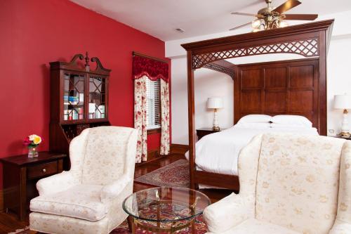 a bedroom with a bed and two chairs and a table at American Guest House, a Washington DC Bed and Breakfast in Washington